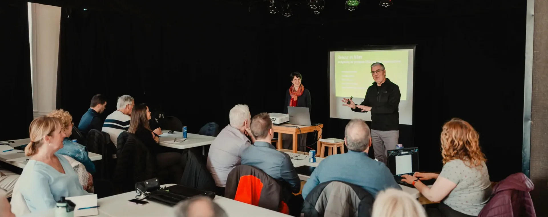 Business presentation to seated audience in classroom