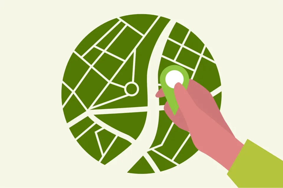 Hand placing location pin on stylized city map