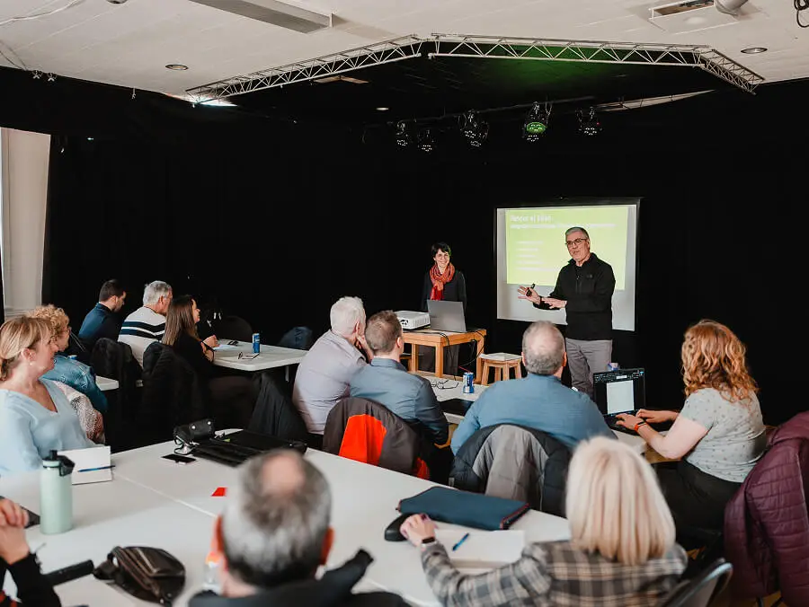 Formation en salle avec présentation et participants attentifs