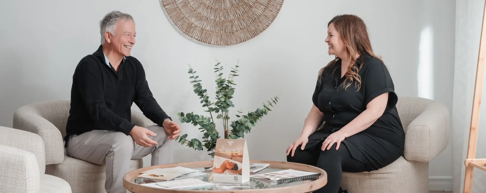 Man and woman chatting in modern office lounge